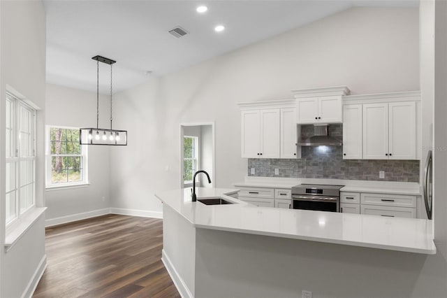 kitchen with a sink, decorative backsplash, white cabinets, and oven