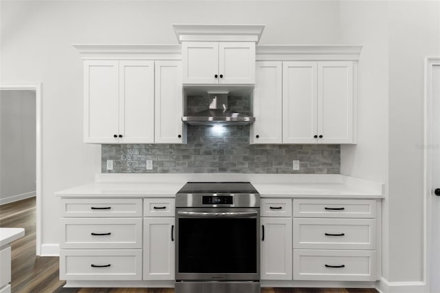 kitchen with light countertops, stainless steel electric stove, decorative backsplash, and wall chimney exhaust hood
