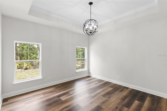 empty room with crown molding, a wealth of natural light, and an inviting chandelier