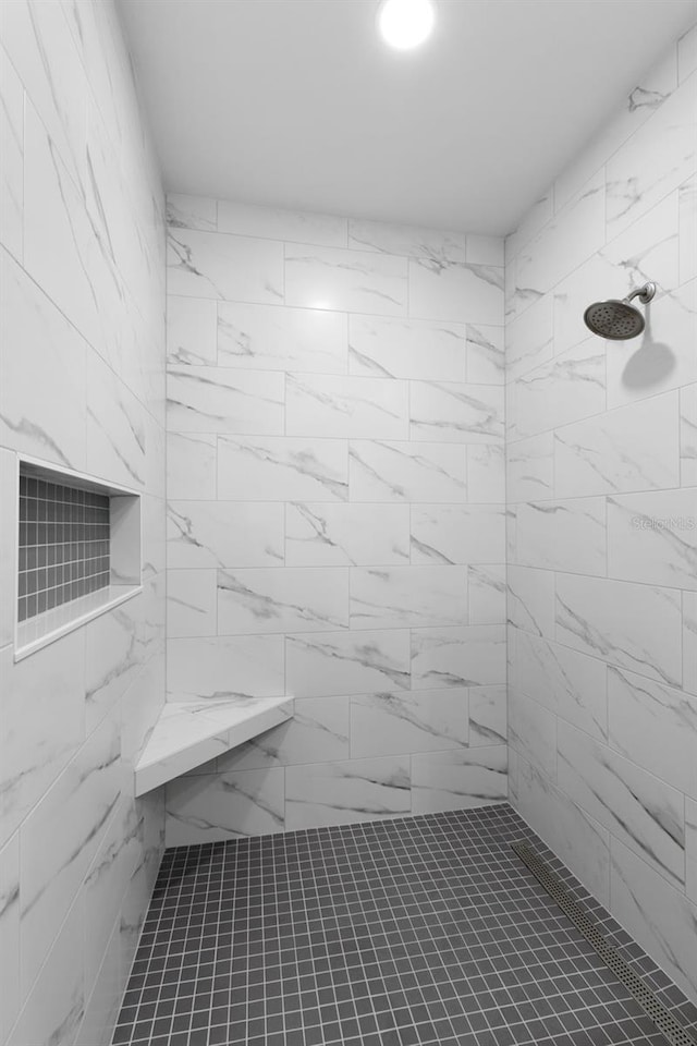 bathroom with a tile shower
