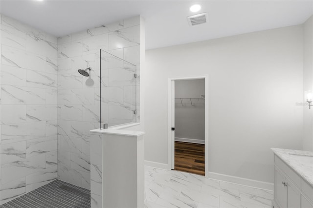 bathroom featuring visible vents, marble finish floor, baseboards, recessed lighting, and a marble finish shower