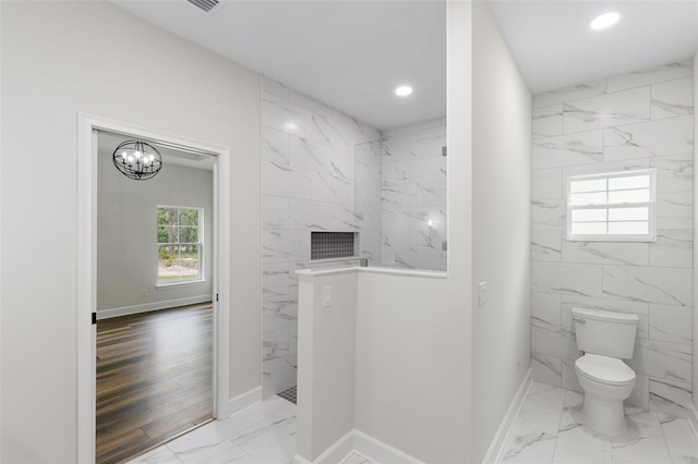 bathroom with baseboards, toilet, marble finish floor, a marble finish shower, and recessed lighting