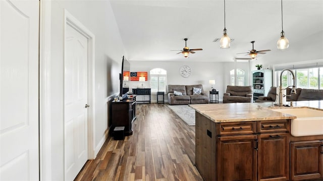 4396 5th Isle Dr, Hernando Beach, FL 34607 - kitchen with ceiling fan, pendant lighting, a sink, light countertops, and dark wood-type flooring
