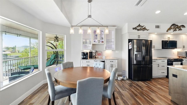 4396 5th Isle Dr, Hernando Beach, FL 34607 - dining room with visible vents, a ceiling fan, dark wood finished floors, and baseboards