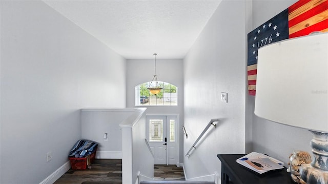 4396 5th Isle Dr, Hernando Beach, FL 34607 - entryway featuring a textured ceiling, baseboards, and wood finished floors