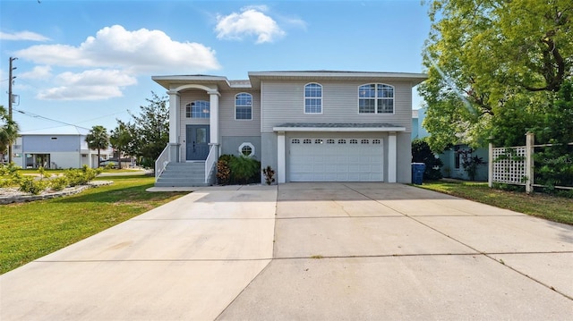 4396 5th Isle Dr, Hernando Beach, FL 34607 - view of front of house featuring a garage, a front lawn, stucco siding, and concrete driveway