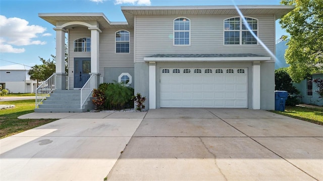 4396 5th Isle Dr, Hernando Beach, FL 34607 - view of front of property with a garage, stucco siding, and driveway