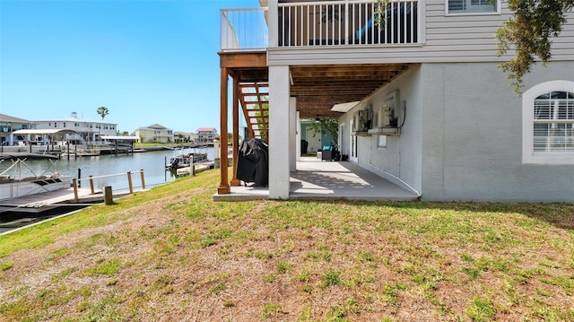 4396 5th Isle Dr, Hernando Beach, FL 34607 - view of yard featuring a water view, a patio area, and a boat dock
