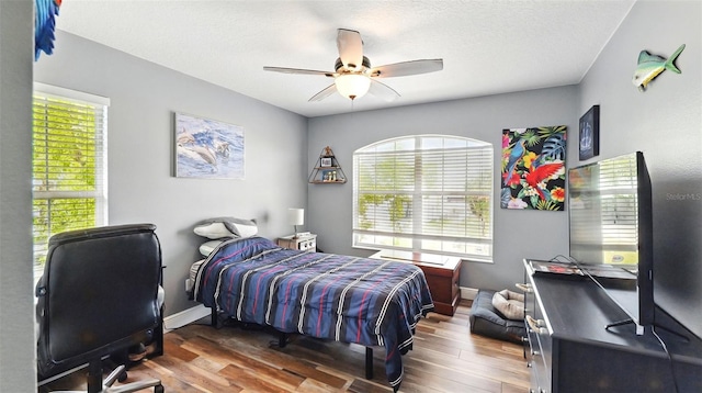 4396 5th Isle Dr, Hernando Beach, FL 34607 - bedroom with baseboards, a ceiling fan, and wood finished floors