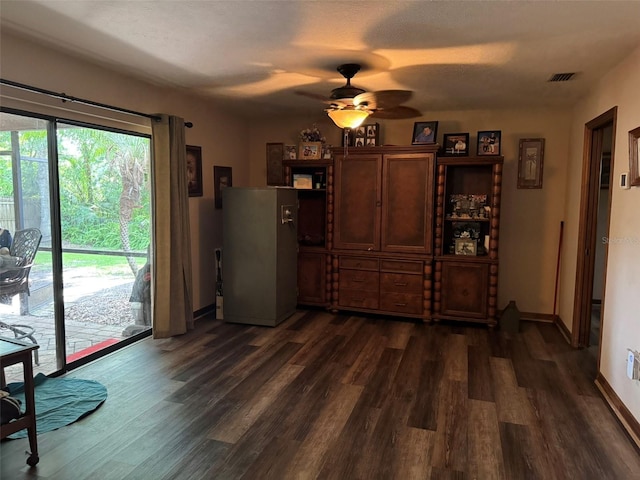 dining space with dark wood-type flooring, ceiling fan, and baseboards