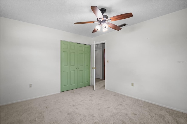 771 Murphy Ave N, Saint Petersburg, FL 33703 - unfurnished bedroom featuring carpet flooring, baseboards, a closet, ceiling fan, and a textured ceiling