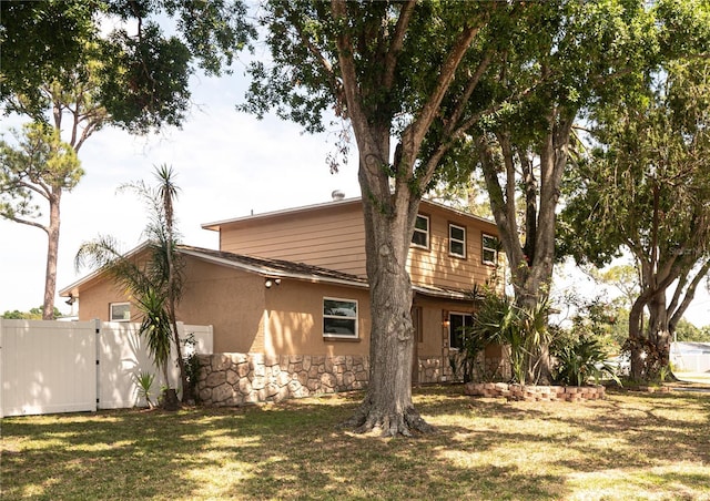 771 Murphy Ave N, Saint Petersburg, FL 33703 - rear view of house with stucco siding and stone siding