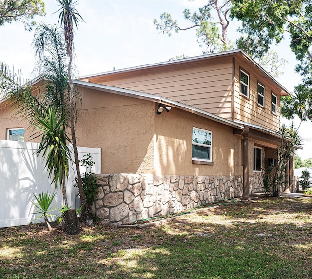 771 Murphy Ave N, Saint Petersburg, FL 33703 - view of side of home featuring stucco siding and stone siding