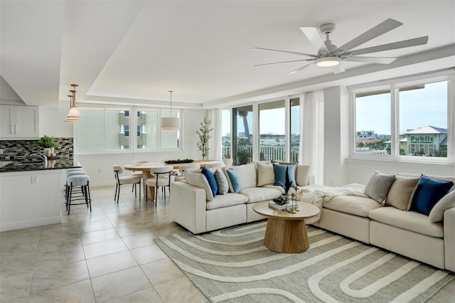 223 Island Way Unit 5D, Clearwater Beach, FL 33767 - living room with baseboards, ceiling fan, and light tile patterned flooring