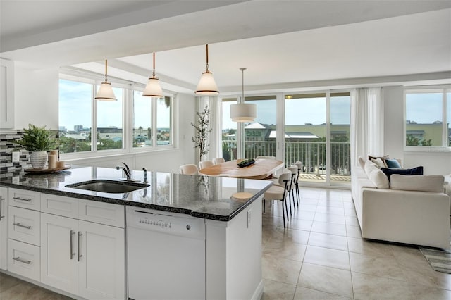 223 Island Way Unit 5D, Clearwater Beach, FL 33767 - kitchen featuring white dishwasher, dark stone counters, plenty of natural light, and a sink
