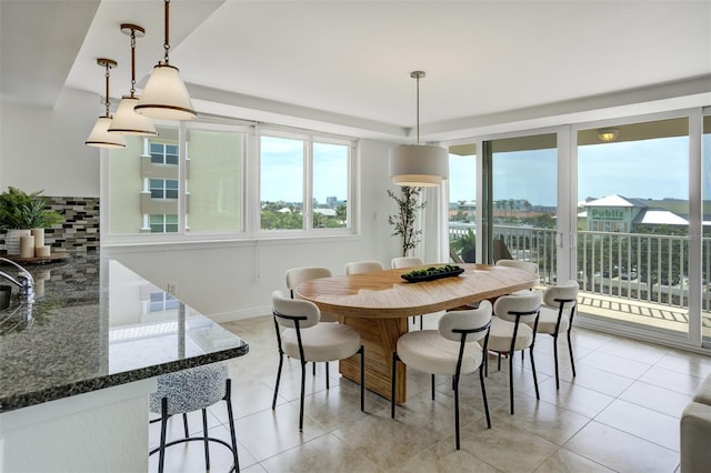 223 Island Way Unit 5D, Clearwater Beach, FL 33767 - dining space with plenty of natural light, baseboards, and light tile patterned floors