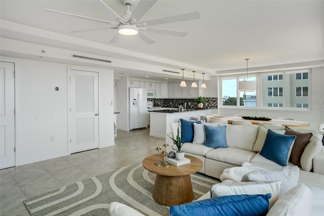 223 Island Way Unit 5D, Clearwater Beach, FL 33767 - living area with light tile patterned flooring, ceiling fan, visible vents, and baseboards