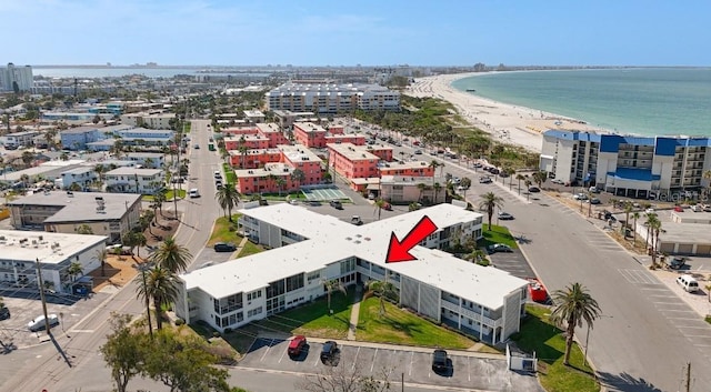 drone / aerial view with a view of city, a water view, and a view of the beach