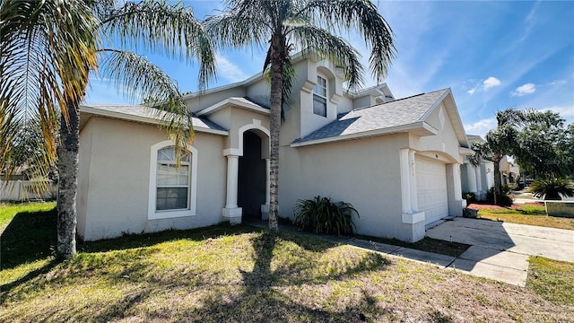 view of front of property with a garage, a front lawn, stucco siding, a shingled roof, and concrete driveway
