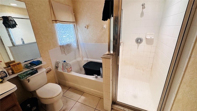 bathroom with a bathing tub, tile patterned flooring, a shower stall, and toilet