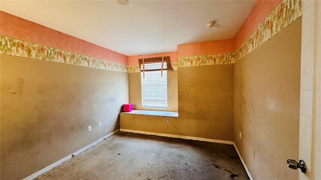 carpeted spare room with baseboards
