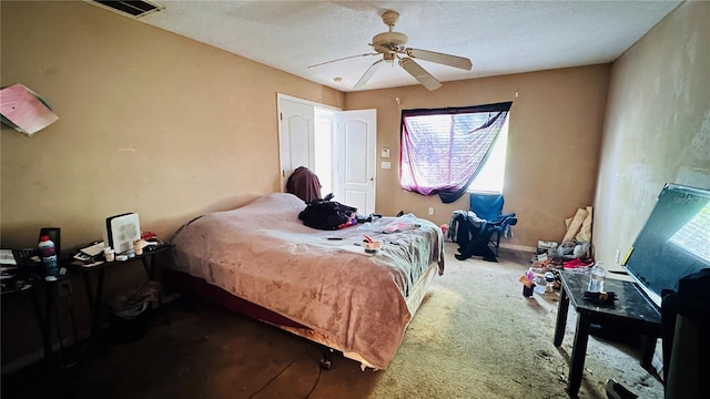 bedroom featuring a ceiling fan, visible vents, and carpet