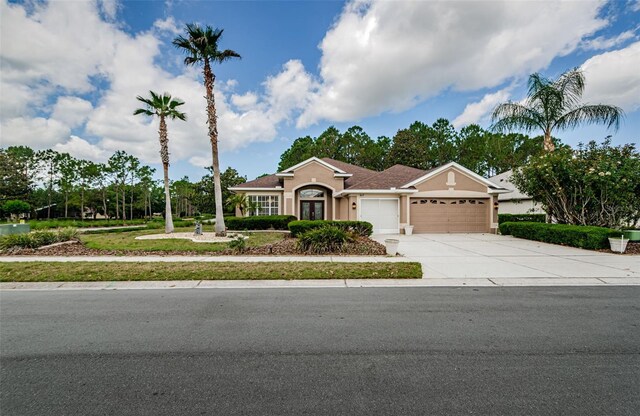 617 Glastonbury Ct, Spring Hill, FL 34609 - ranch-style home with a garage, stucco siding, and driveway