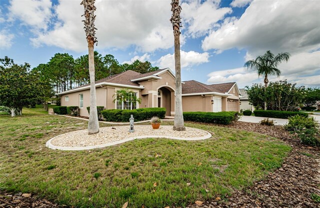 617 Glastonbury Ct, Spring Hill, FL 34609 - single story home with stucco siding, a front yard, concrete driveway, and an attached garage