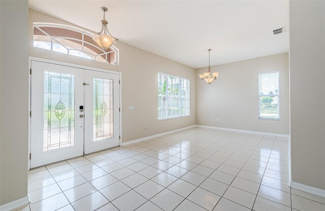 617 Glastonbury Ct, Spring Hill, FL 34609 - foyer entrance with a chandelier, healthy amount of natural light, and light tile patterned floors
