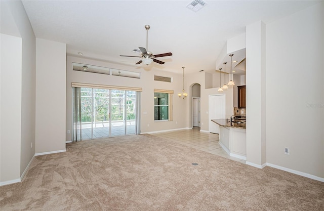 617 Glastonbury Ct, Spring Hill, FL 34609 - unfurnished living room with light carpet, a ceiling fan, arched walkways, and baseboards