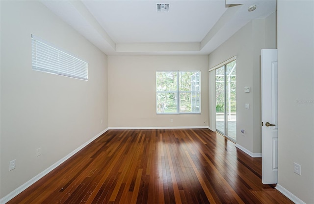 617 Glastonbury Ct, Spring Hill, FL 34609 - spare room featuring hardwood / wood-style flooring, a raised ceiling, baseboards, and a smoke detector