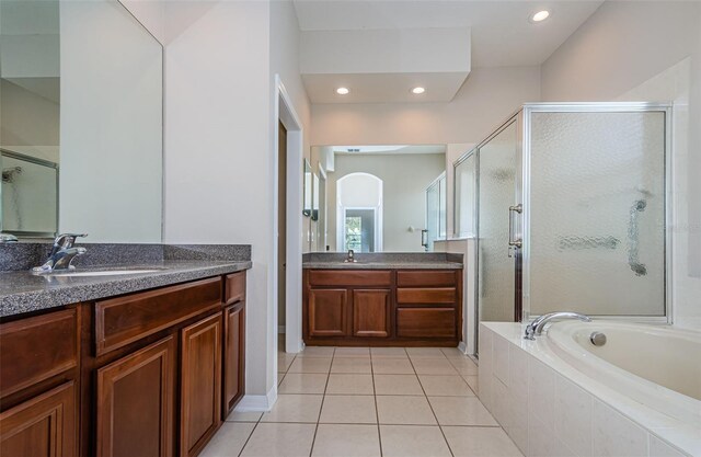 617 Glastonbury Ct, Spring Hill, FL 34609 - full bath with a shower stall, a bath, tile patterned flooring, two vanities, and recessed lighting