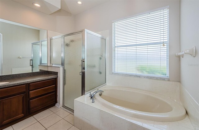 617 Glastonbury Ct, Spring Hill, FL 34609 - bathroom featuring a stall shower, a garden tub, vanity, and tile patterned flooring