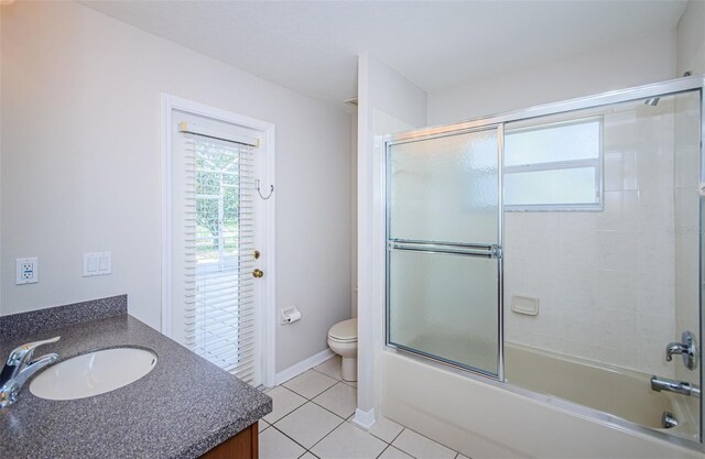617 Glastonbury Ct, Spring Hill, FL 34609 - bathroom featuring vanity, toilet, tile patterned floors, enclosed tub / shower combo, and baseboards
