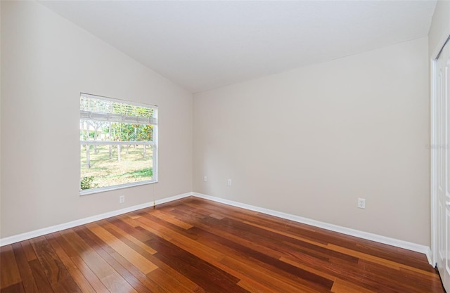 617 Glastonbury Ct, Spring Hill, FL 34609 - empty room with wood-type flooring, lofted ceiling, and baseboards