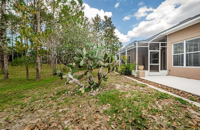 617 Glastonbury Ct, Spring Hill, FL 34609 - view of yard featuring a patio area and glass enclosure