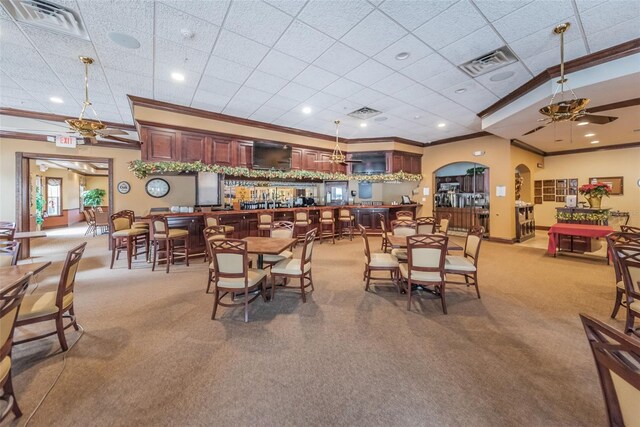 617 Glastonbury Ct, Spring Hill, FL 34609 - dining room featuring crown molding, a ceiling fan, carpet floors, arched walkways, and baseboards
