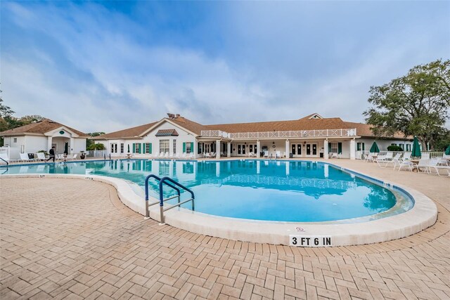 617 Glastonbury Ct, Spring Hill, FL 34609 - community pool with a patio area and fence