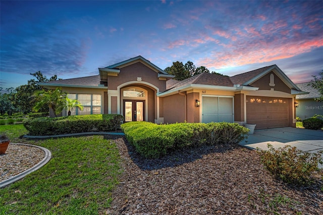 617 Glastonbury Ct, Spring Hill, FL 34609 - view of front of house with french doors, stucco siding, a garage, driveway, and a front lawn