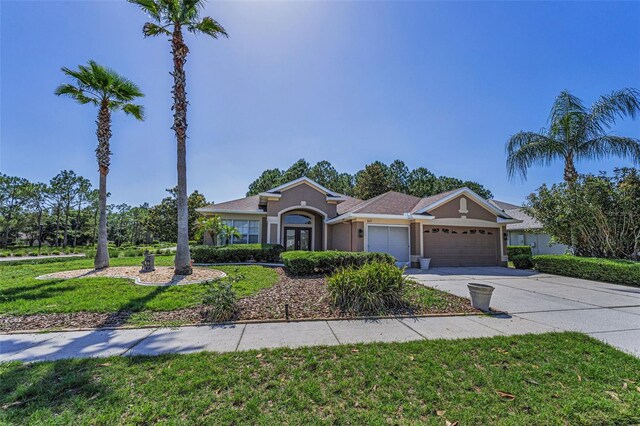 617 Glastonbury Ct, Spring Hill, FL 34609 - single story home with a garage, driveway, stucco siding, and a front lawn