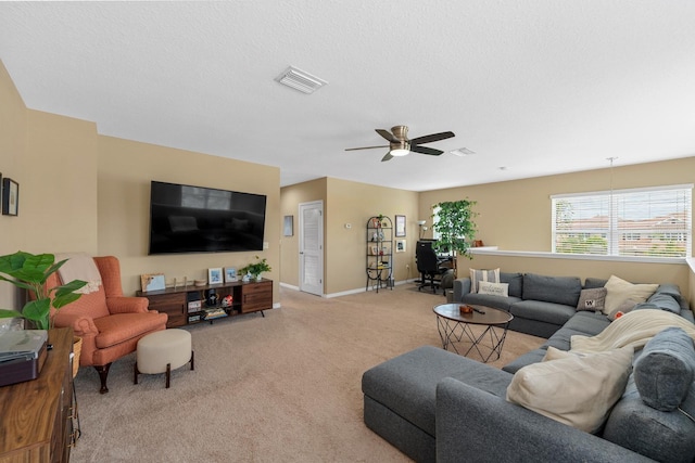 living area with light colored carpet, ceiling fan, visible vents, and baseboards