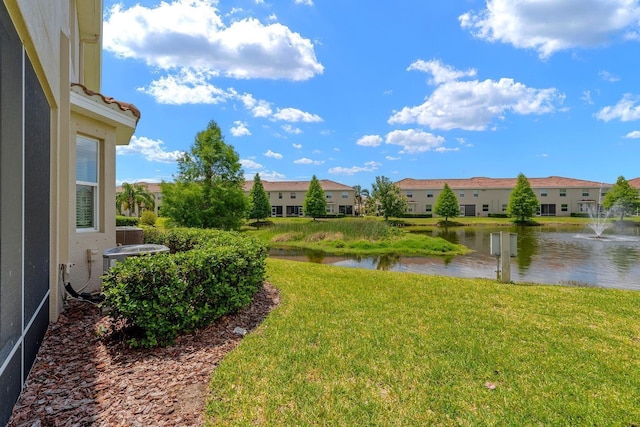 view of yard featuring a residential view and a water view