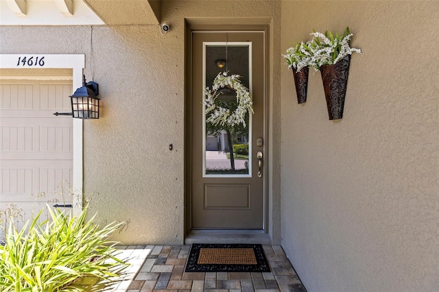 property entrance featuring stucco siding