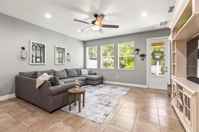 living room featuring a ceiling fan, baseboards, visible vents, and recessed lighting