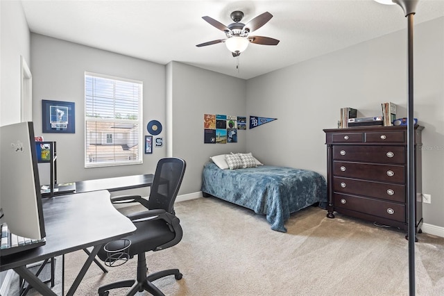 bedroom featuring light colored carpet, a ceiling fan, and baseboards