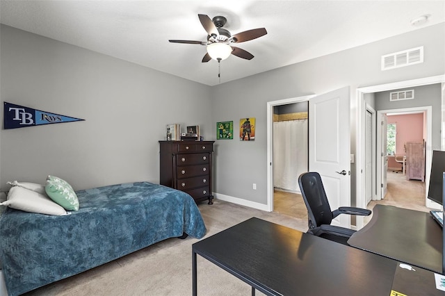 bedroom featuring a ceiling fan, light colored carpet, and visible vents