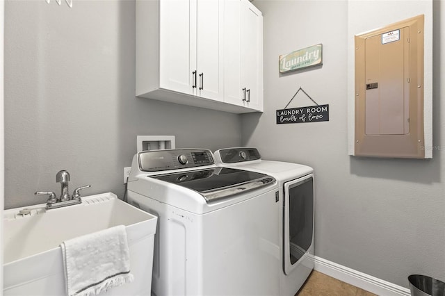 laundry area featuring electric panel, cabinet space, a sink, baseboards, and washer and dryer