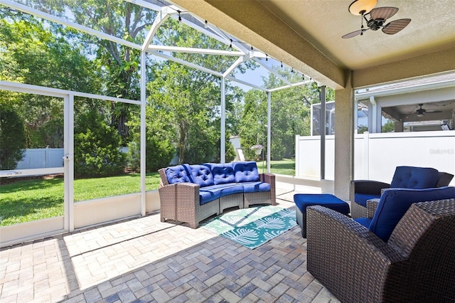 sunroom featuring ceiling fan and an outdoor living space