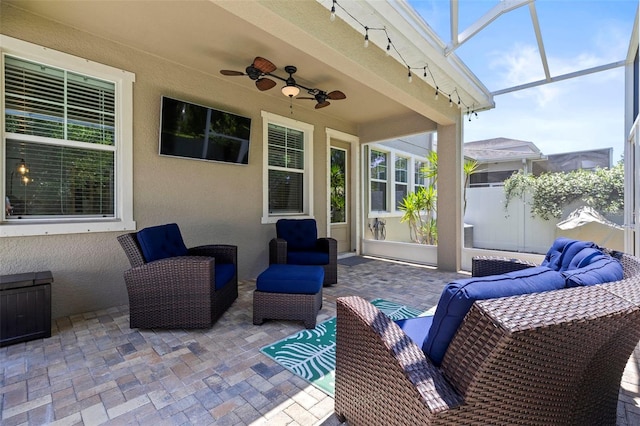 view of patio / terrace featuring a ceiling fan, fence, and an outdoor hangout area