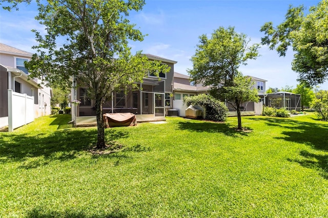 back of house with a lawn and a sunroom